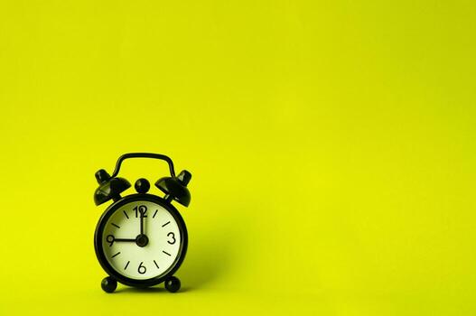 Alarm clock pointing at 9 am or pm with customizable space for text or ideas. Copy space. photo