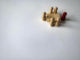 Wooden people figures having business meeting with customizable space for text. Business concept and copy space photo