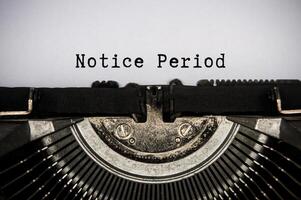 Notice period text typed on an old vintage typewriter. Employment and termination concept photo