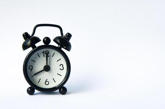 Alarm clock pointing at 8 am or pm with customizable space for text or ideas. Copy space. photo