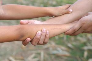 The hands of a child and a mother join forces. photo