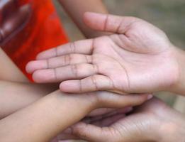 The hands of a child and a mother join forces. photo