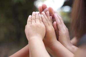 The hands of a child and a mother join forces. photo