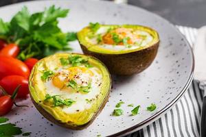 Avocado baked with egg and fresh salad. Vegetarian dish. Ketogenic diet. Keto food photo