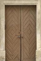 Old ancient wooden door texture in european medieval style photo