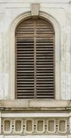 Texture of aged wooden window of ancient medieval building photo