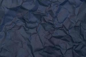 Wrinkled or crumpled black stencil paper or tissue after use in toilet or restroom with large copy space used for background texture in art work. photo