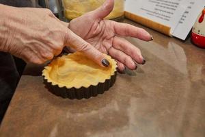 Process of making the base for Round Cream Pie with Chocolate and Strawberries. French recipe photo