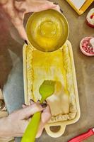 Chef dunks an egg on souffle made from French potatoes, zucchini, cauliflower and yellow cheese photo