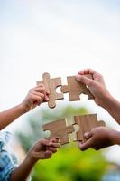 jigsaw and hands Combine the power of unity, teamwork, teamwork. photo