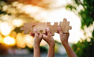 jigsaw and hands Combine the power of unity, teamwork, teamwork. photo