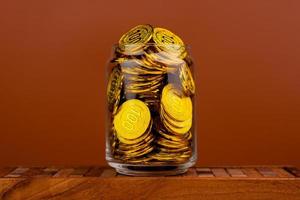 Gold Coins Save gold coins in glass jars. Concept of having money, having time and having a house photo