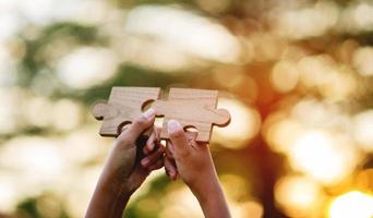 jigsaw and hands Combine the power of unity, teamwork, teamwork. photo