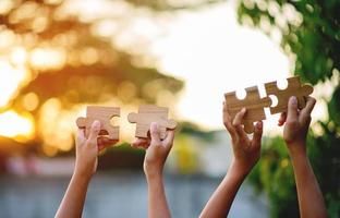 jigsaw and hands Combine the power of unity, teamwork, teamwork. photo