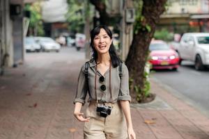 Young Asian woman backpack traveler enjoying street cultural local place and smile. photo