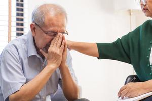 Psychology, depression people. Elderly asian patient man, male consult with psychologist, psychiatrist. Older doctor woman consulting, counseling mental health at clinic. Encouraging, therapy. photo