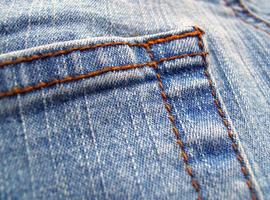 Fragment of classic blue fashioned jeans photo