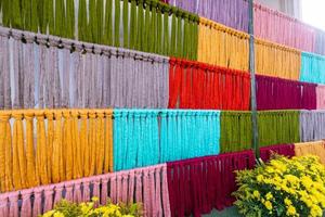 Many of the threads that are dyed brightly are the ones that have been prepared for the traditional loom because the fabric woven on the traditional loom is handmade and expensive. photo