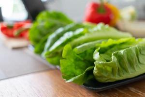 young woman preparing lettuce As an ingredient in breakfast menu and ready for cooking healthy meals and on table there are also vegetables that are organic ingredients that help maintain healthy diet photo