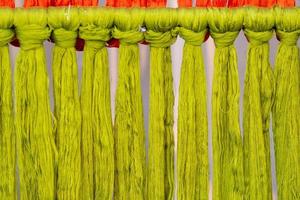 Many of the threads that are dyed brightly are the ones that have been prepared for the traditional loom because the fabric woven on the traditional loom is handmade and expensive. photo