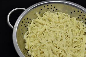 Vermicelli after cooking. Pasta in a colander. photo