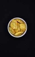 Yellow spicy crackers in a bowl. Breadcrumbs for beer. Snack. photo