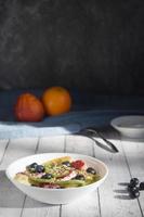 vertical photo still life, plate with fruit salad , rustic