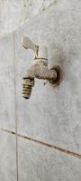 Portrait of a white water faucet. photo