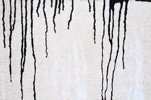 Stained Black Painting on Grunge Concrete Wall Texture Background. photo