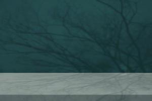 Marble Table with Bokeh and Branch Shadow on Concrete Wall Texture Background in Tidewater Green Tone, Suitable for Product Presentation Backdrop, Display, and Mock up in Halloween Concept. photo
