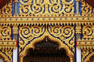 Vintage Golden Thai Traditional Sculpture in front of Buddhist Church. photo