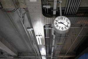 Analog Clock Hanging on Ceiling. photo