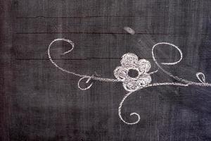 Flower Hand Drawing in Doodle Style on Chalkboard. photo