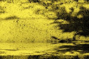 Old Grunge Concrete Table with Leaves Shadow on Wall in Gold Tone. photo