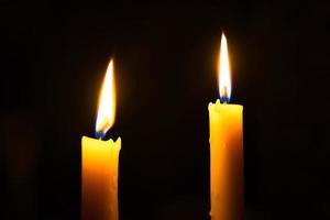 2 candle lights in the dark photo