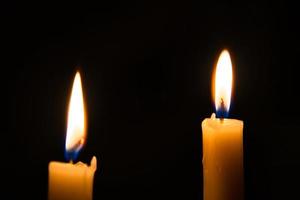 2 candle lights in the dark photo