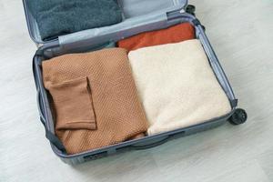 winter clothes in luggage. Time to travel, trip, Relax, spring or autumn or winter season and vacation concepts photo