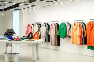 A showcase with fashionable colorful clothes in the store photo