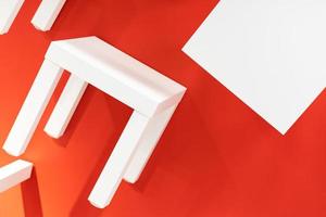 many white chair or table on red background. photo