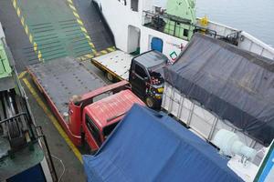 the atmosphere of the Bali crossing ferry vehicle deck full of vehicles photo