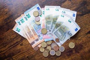 Euro banknotes and coins are on the table photo