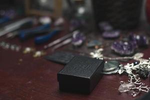 Close up packaging handmade jewelry in custom dark box concept photo