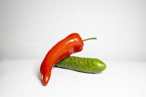 Fresh Cucumber and red pepper isolated on white background tasty and healthy food flat side view photo