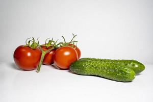 Photo tomato and cucumber on a white background selective focus copy space