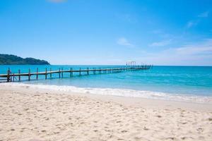 Seascape view with A wooden pier that stretches out to the sea and cloudy sky for travel in holiday relax time as summer photo