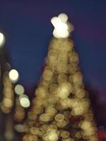 Blur light celebration on christmas tree with bokeh background photo