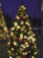 Blur light celebration on christmas tree with bokeh background photo