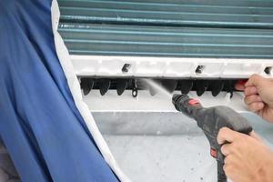 air conditioning cleaning service with water spray photo