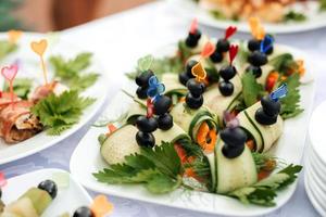 ligero aperitivos, canapés en un festivo mesa foto