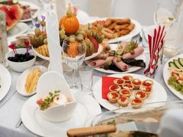 the table is served for the celebration with snacks and alcohol photo